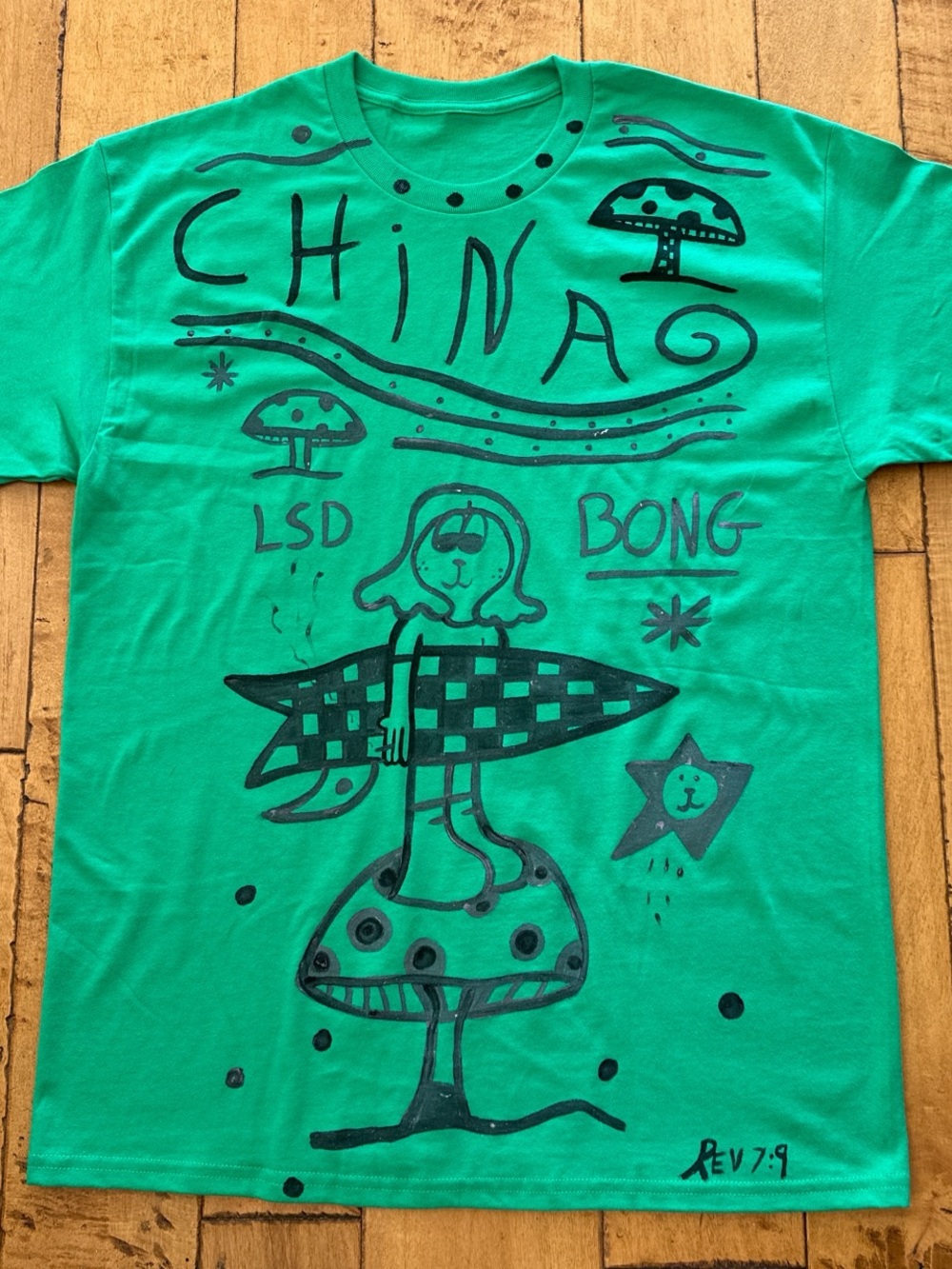 Green Graphic T-Shirt with Surfing Mushroom Design